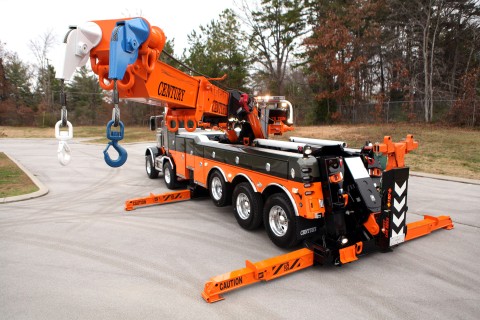 orange and black century 1075s rotator with outriggers and boom extended