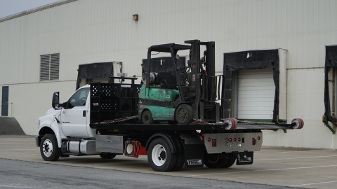 titan c series loaded with forklift on the bed