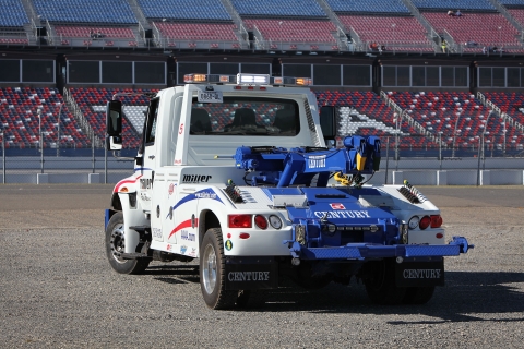 white and blue century 602 wrecker at nascar racetrack