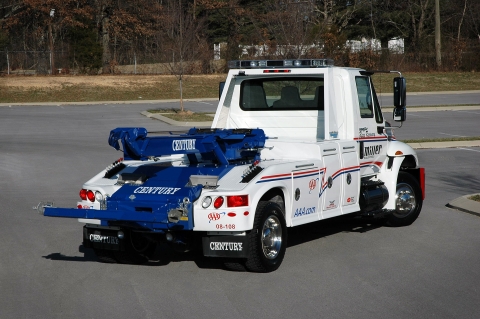 white and blue century 602 wrecker in a parking lot