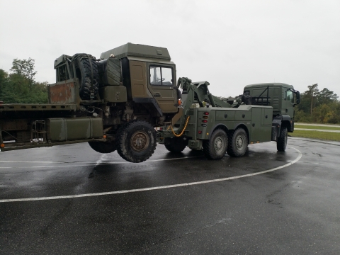 5230 towing a military flat bed truck