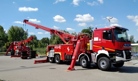 Image showing a government fire department usage of a Century 1060 to lift heavy equipment after responding to a fire.