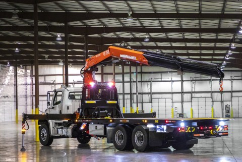 The image shows a Century R30 Industrial Carrier with the crane and outriggers extended.