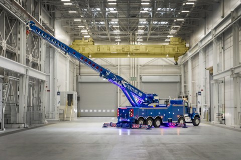 century m100 with boom and outriggers fully extended in an industrial building