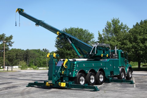 green vulcan 975 rotator with boom extended and rotated and outriggers extended