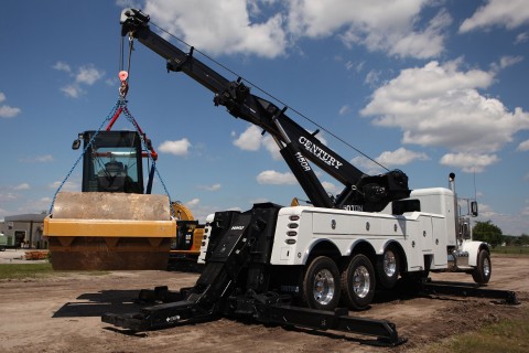 century 1150r lifting a piece of paving equipent