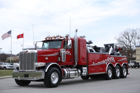 Red and black 50-ton integrated Century 9055 on a Peterbilt 389 chassis