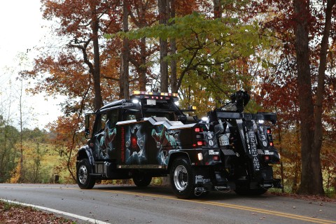 rear photo of a black vulcan v-30 on a freightliner m2 chassis on empty road