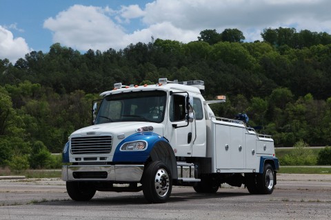 front photo of a white and blue vulcan v-30 in an empty lot