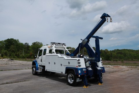 rear side photo of a white and blue vulcan v-30 on a freightliner m2 chassis stretched out