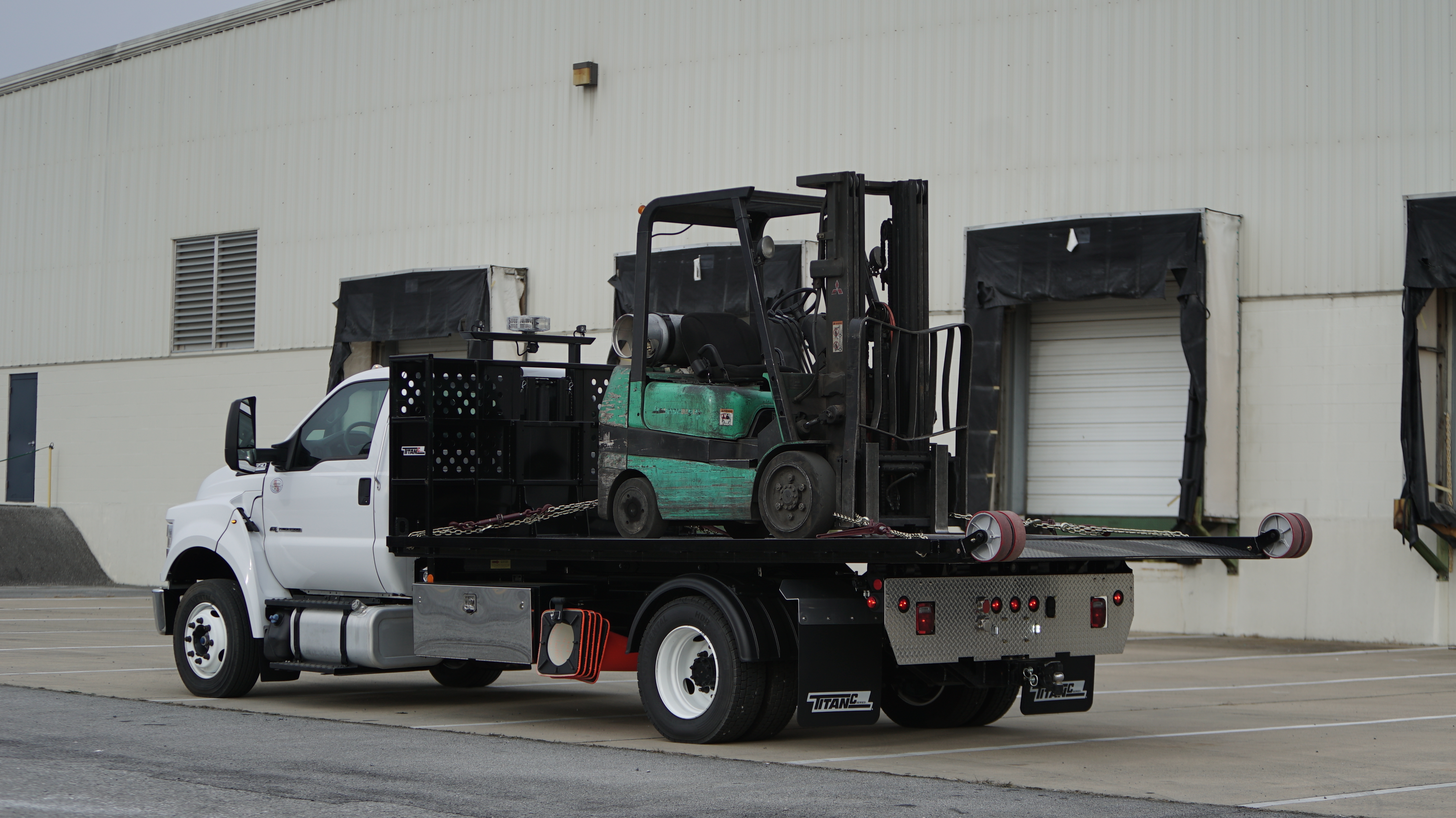 The Titan® C-Series transporting a fork truck