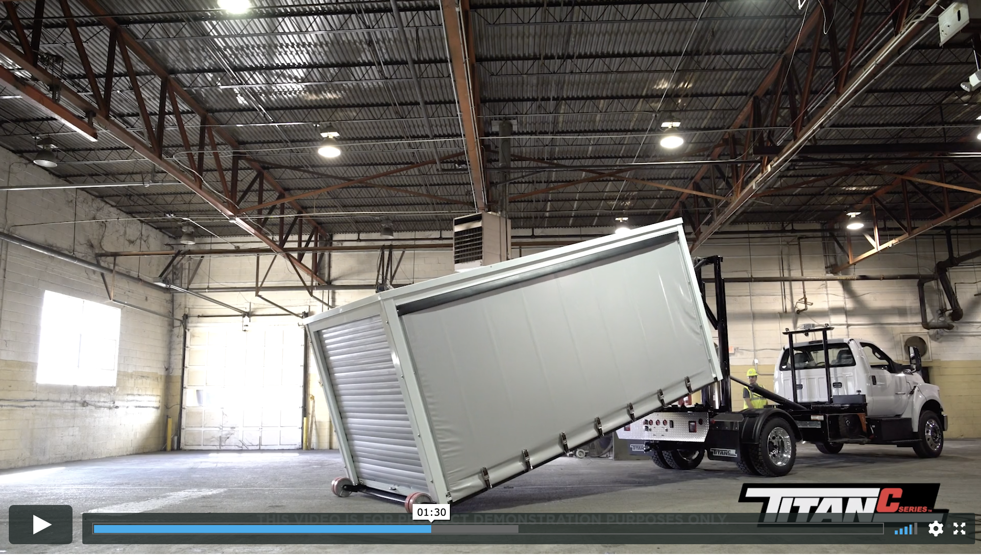 Titan® C-Series video showcases Miller Industries roll-off system for equipment and freight transport.