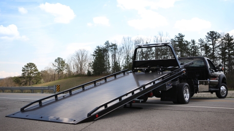 black 10 series carrier with steel deck slid back along roadside