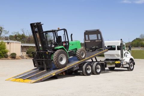 This photos shows a Century 20-Series LCG Carrier loading a fork truck