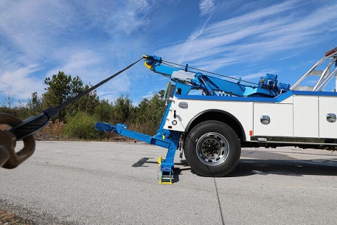 This photos shows one of Miller Industries 16-Ton Wreckers, a Century 3212, with its extendable 2-stage recovery boom extended to provide more work area off the rear of the tailboard.