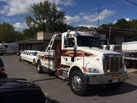 This picture shows how a Century® 3212 mounted on a Peterbilt truck is a perfect integrated wrecker for medium-duty towing of limo, box trucks, and other vehicles.