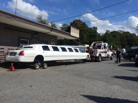 In this picture a Century® 3212 is towing a limo with it's 4,000 lb. aluminum L-Arms.