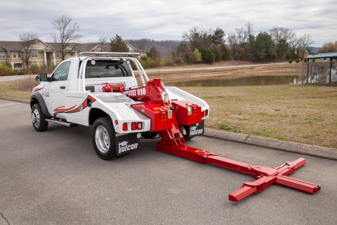 white and red vulcan 810 wrecker with underlift down and extended