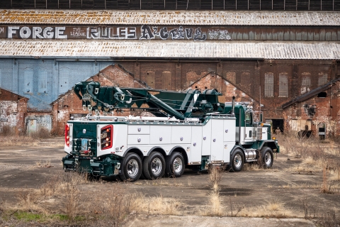 white and green century m100 on a kenworth c500 chassis at an old factory