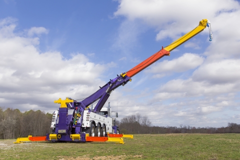 white and purple vulcan 975 rotator with boom and outriggers extended