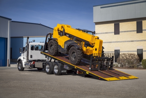 This photo shows a Century 20-Series LCG carrier loading a telehandler.