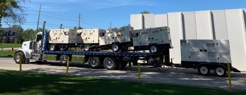 Image shows a loaded 40-series industrial carrier from Miller Industries carrying industrial generators.