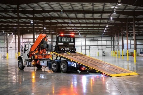 This photo shows the Century R30 industrial carrier from miller industries with the carrier deck deployed.