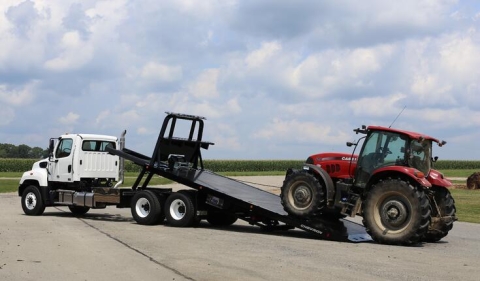 Image showing a Chevron 30-Series Industrial Carrier loading a large tractor.