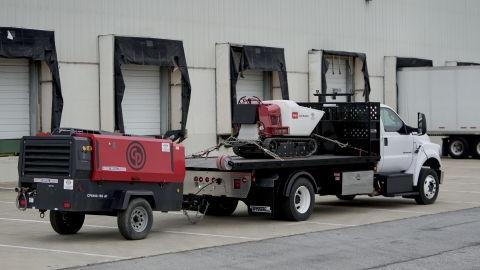 titan c series loaded with rental equipment on the deck and the hitch