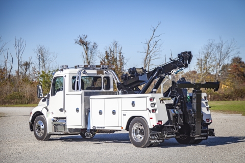 white and black holmes 600r on a kenworth chassis