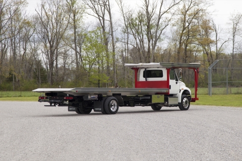 white and red chevron 4 car carrier on a freightliner m2 chassis