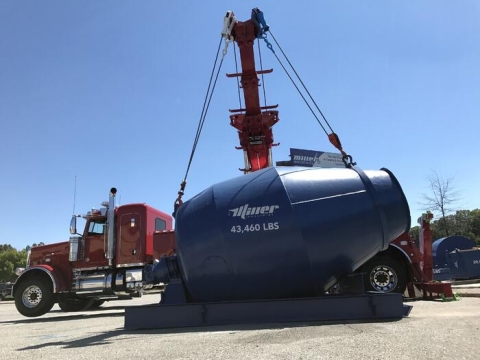 Image of a Century 1150 rotator picking up a 43 thousand pound mixer drum.
