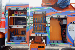 Image show the fork storage and the slide-out shelf toolbox storage system available on the Century®️ line of rotators.