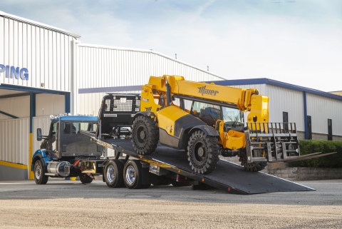 This image shows a rear view of a Vulcan 20-Series LCG carrier loading a telehandler.