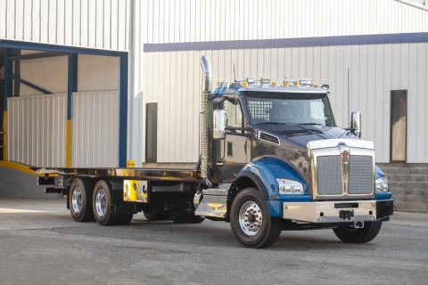 This image shows a Vulcan 20-Series LCG carrier mounted on a Kenworth truck chassis