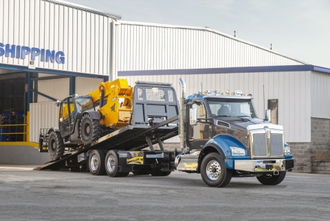 This image shows a front view of a Vulcan 20-Series LCG carrier loading a telehandler.