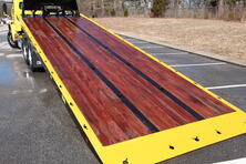 Image showing the Apitong wood deck option for industrial carriers from Miller Industries.