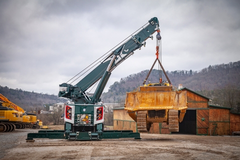 century m100 rotator lifting a komatsu dozer off of the side