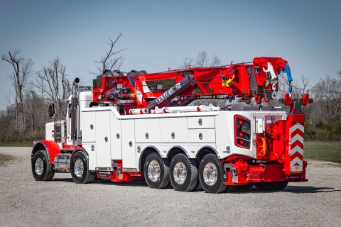 white and red century m100 rotator on a peterbilt 389 chassis in a gravel lot