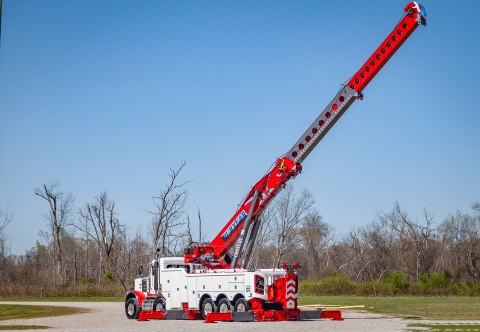 white and red century m100 rotator with boom and outriggers fully extended