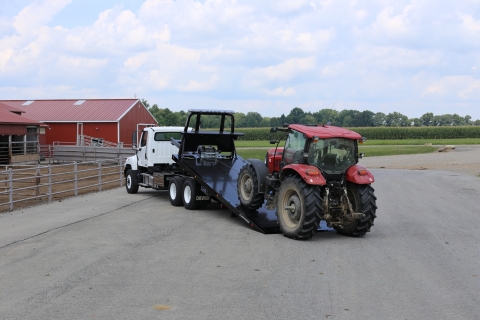 Chevron 30-Series Conventional Carrier loading a tractor
