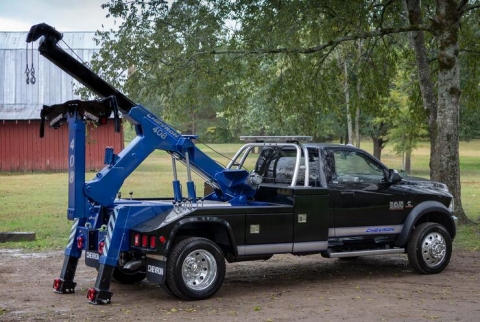 Image shows a Chevron™️ 408 autoloader with two-stage recovery boom fully extended and elevated.