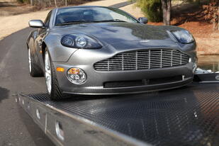 Image showing the additional clearance provided by the SST car carrier option as an operator is loading a low profile sports car.