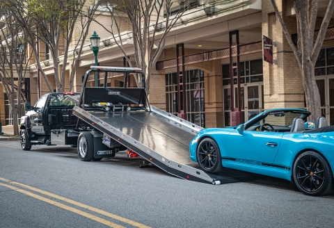 black century 10 series carrier with right approach option loading a blue porsche 911 carerra convertible