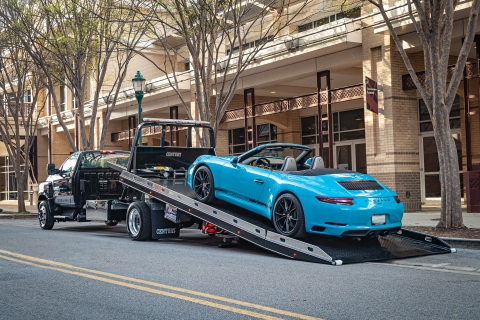 blue porsche 911 carerra loaded on a century 10 series steel bed carrier with right approach option