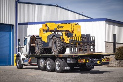 Image shows a century R30 industrial carrier with the bed stowed and loaded from the rear.