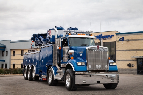 front of a blue century m100 rotator on a kenworth w900 chassis