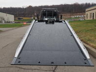 Image showing the rear view of a Century Car Carrier with the steel bed extended and elevated. This shows the wide provided by have the optional blade rails.