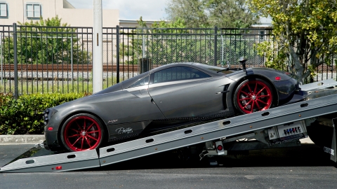 carbon fiber pagani huayra being loaded on a century 12 series lcg carrier with right approach option
