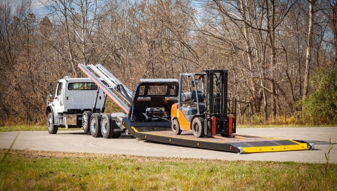 titan zla industrial carrier with bed back on the ground loaded with a forklift